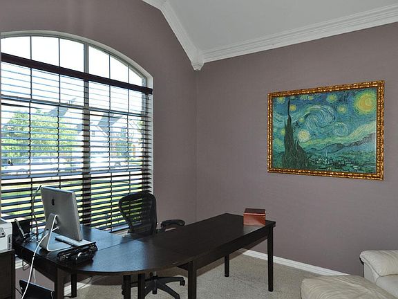 Large study with crown molding and French doors.