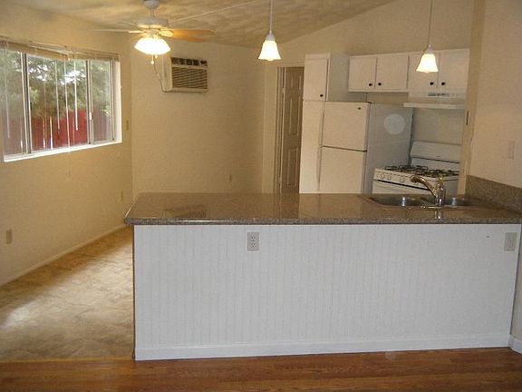 Living Room looking into Kitchen with Granite Tops!