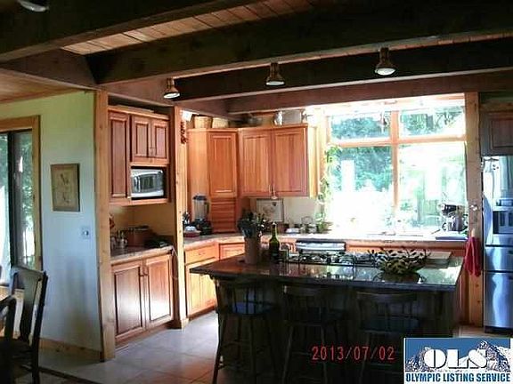 The design is actually a great room with guests and chef easily mixing. The kitchen was recently remodeled to feature cherry cabinets and slab granite counters. You could feel as though you are living in a tree house looking out each window.