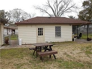 Detached one car garage with a covered patio on back.