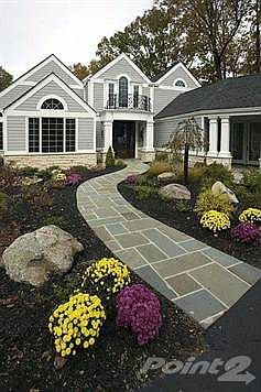 Wonderful architecture accents added to this home...a beautiful mix of stone, thick pillars and woodwork, glass doors and black iron accents.