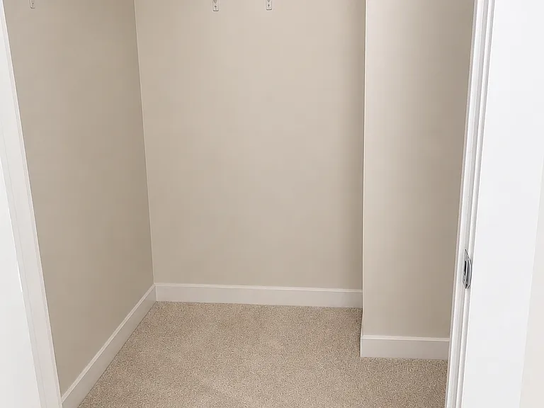Walk-in closet off of secondary bedroom