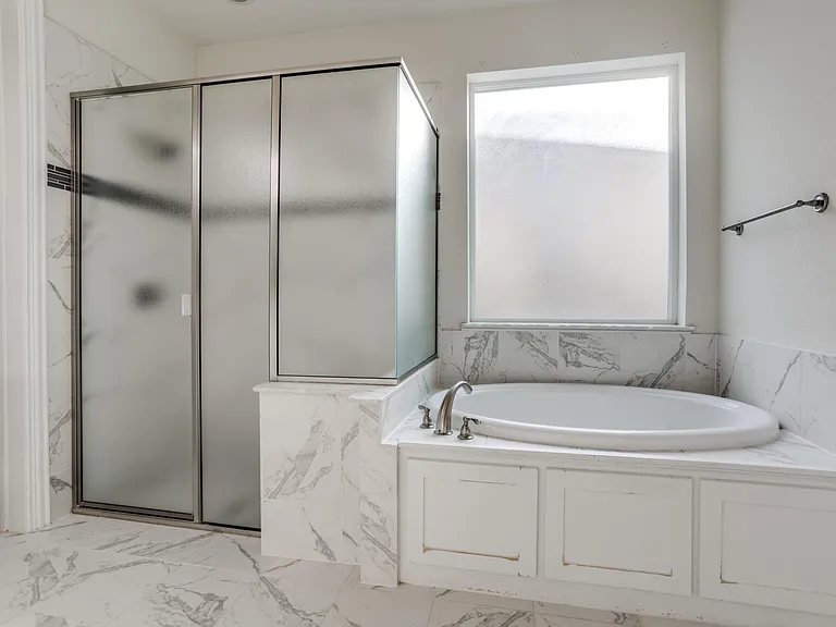 Bathroom featuring tile floors and shower with separate bathtub