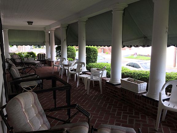 Grand front and side porch with brick floor