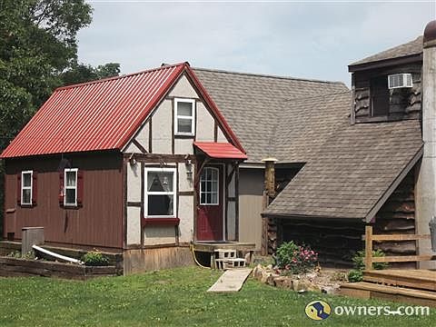 Cottage and back of new sunroom.