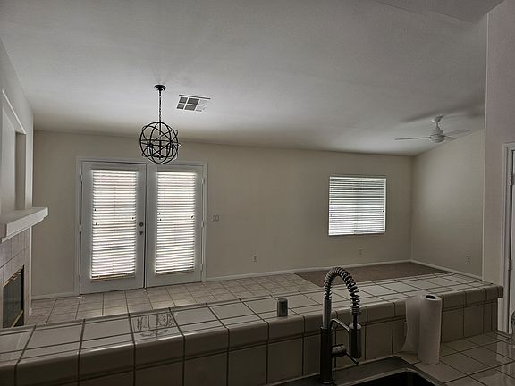 Kitchen w/ breakfast bar overlooks informal eating area/Family room w/Fireplace and ceiling fan