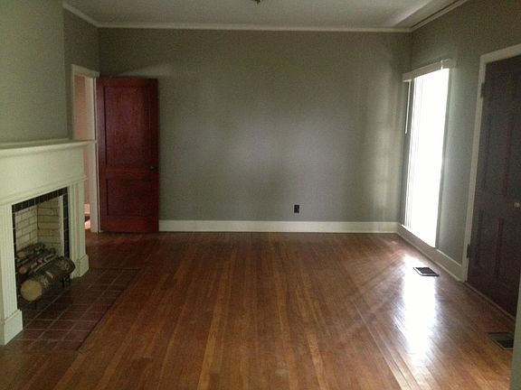 Large living room with hardwood floors and lots of natural l