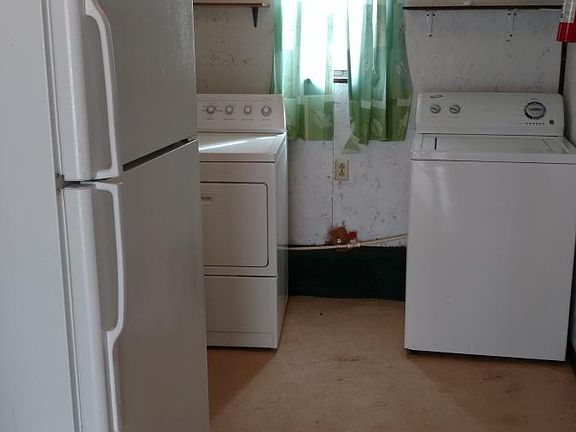 utility room with washer and dryer and extra fridg. 