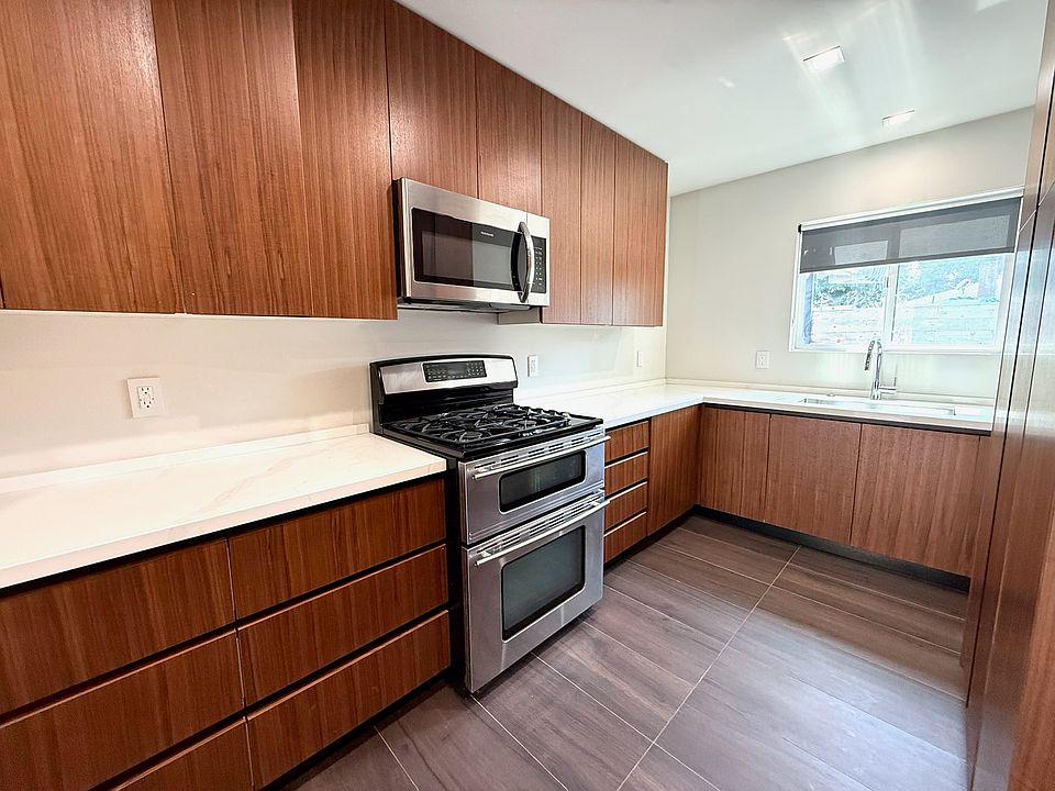 Kitchen with dishwasher, microwave, gas cooktop, and dual zone oven.