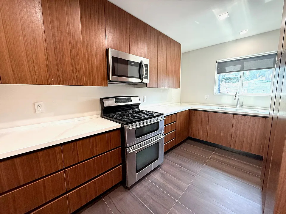 Kitchen with dishwasher, microwave, gas cooktop, and dual zone oven.