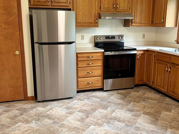 kitchen with new refrigerator, stove and hood and closet/pantry