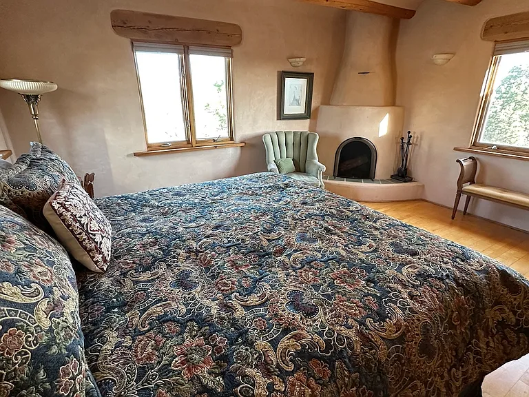 Upstairs master bedroom with kiva fireplace, views