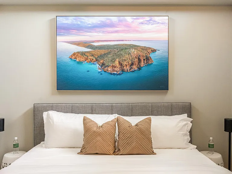 Boasting tall ceilings, the bedroom combines comfort and style for a truly luxurious retreat.