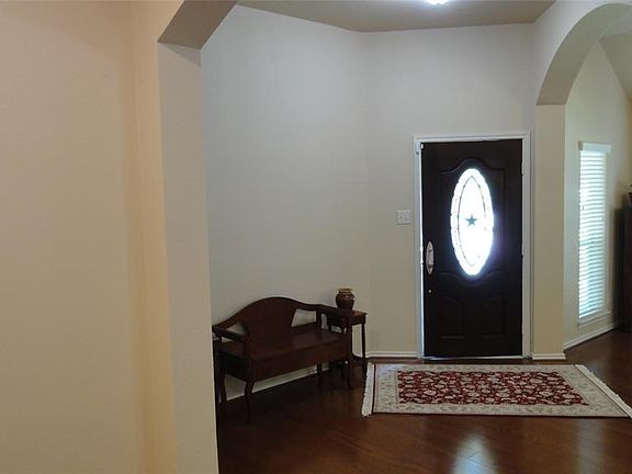 Imagine yourself in this snapshot entering the foyer gazing upon the archways and wood flooring.
