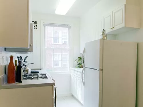 Kitchen with white cabinetry and appliances - eaves Tunlaw Gardens