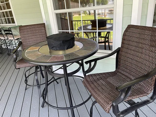 This is a high table and chairs with small fire pit on the main screened porch, just off of the breakfast nook.