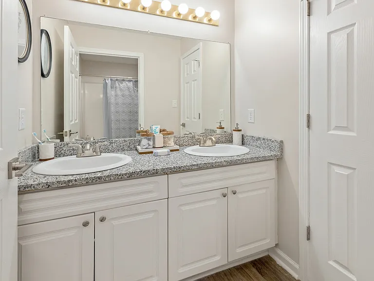 Elegant Bathroom with Double Vanity Sinks and Gold Accents