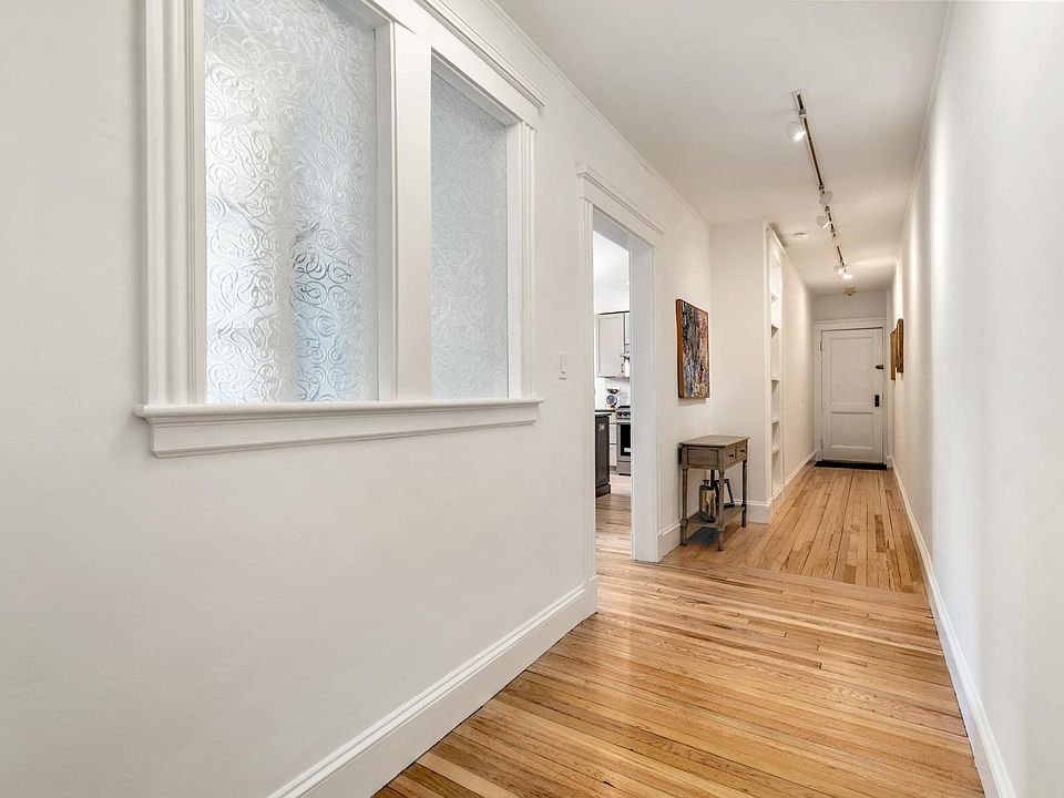 Reverse view of hallway, showing decorative glass windows of study.