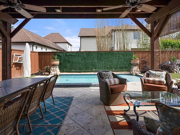 Enjoy al fresco dining at the covered patio while looking at the sparkling pool.