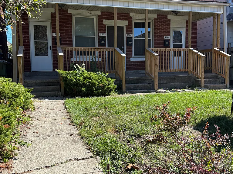 Exterior of 4-unit building. New porch recently installed. Building is old but well-maintained. We spend about $25K/year in maintenance and upgrades.