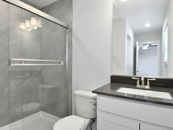 The master bathroom has a large vanity and step in shower.