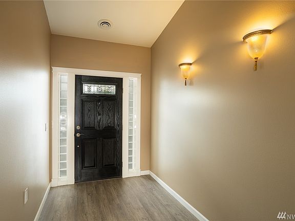 Front door entry shows the new flooring and paint colors. If you need extra wide halls for passage then this is your home.