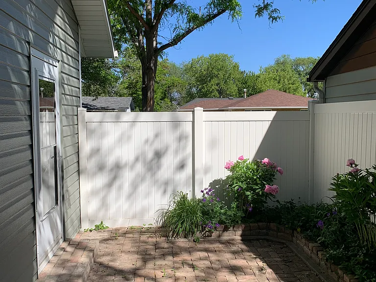 Backyard brick patio outside of front bedroom/office