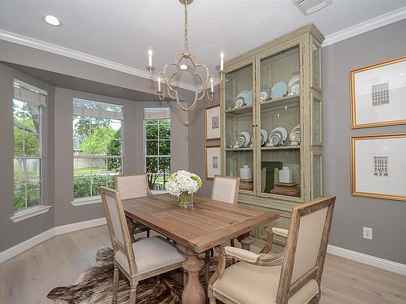 And to the other side of the entry is the formal dining area. The bay window allows lots of natural light. Designer chandelier and additional canned lighting make this room light and inviting!