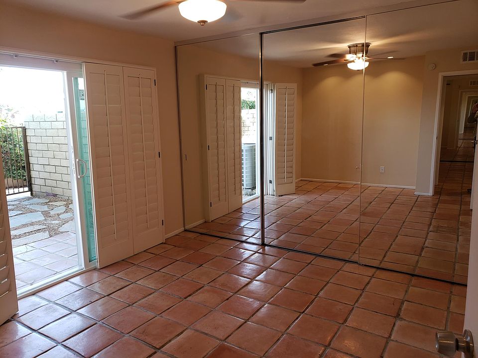 Room #1 with beautiful Spanish style tiles with a large mirror closet for plenty of storage and easy access enclosed backyard.