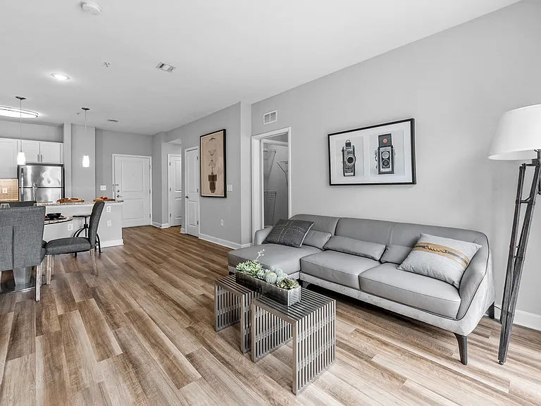 a living room with hardwood flooring and grey couch at Harbor Pointe, Bayonne, 07002