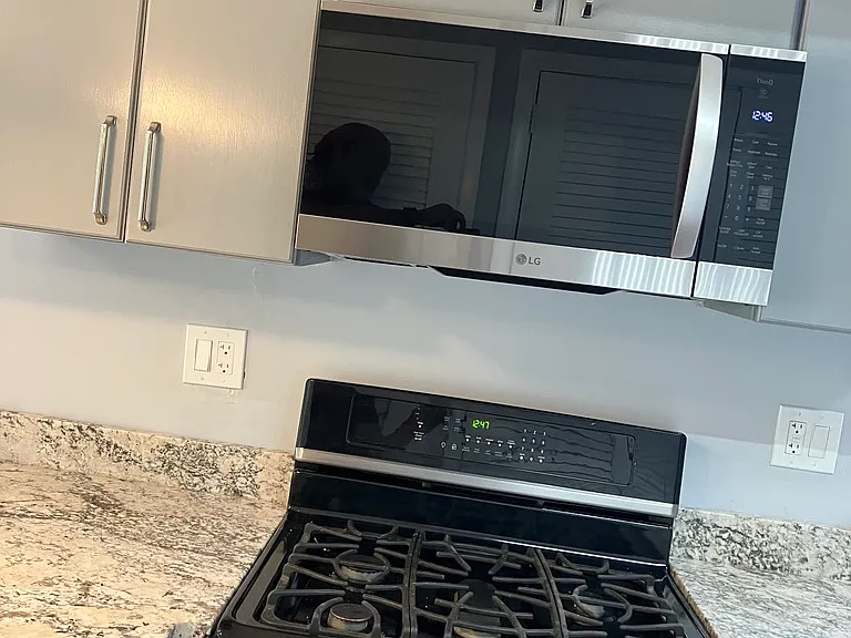 Five-burner gas stove and microwave.