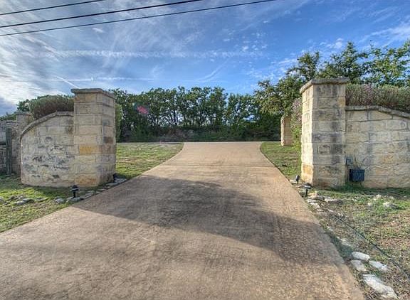 Stone Front Entry from the Bee Creek Road to enter, ready to add your private entry gate!