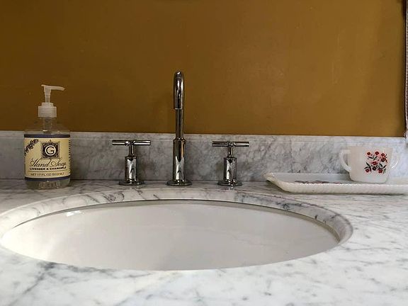 Marble countertops and Kohler fixtures in the recently renovated bathroom