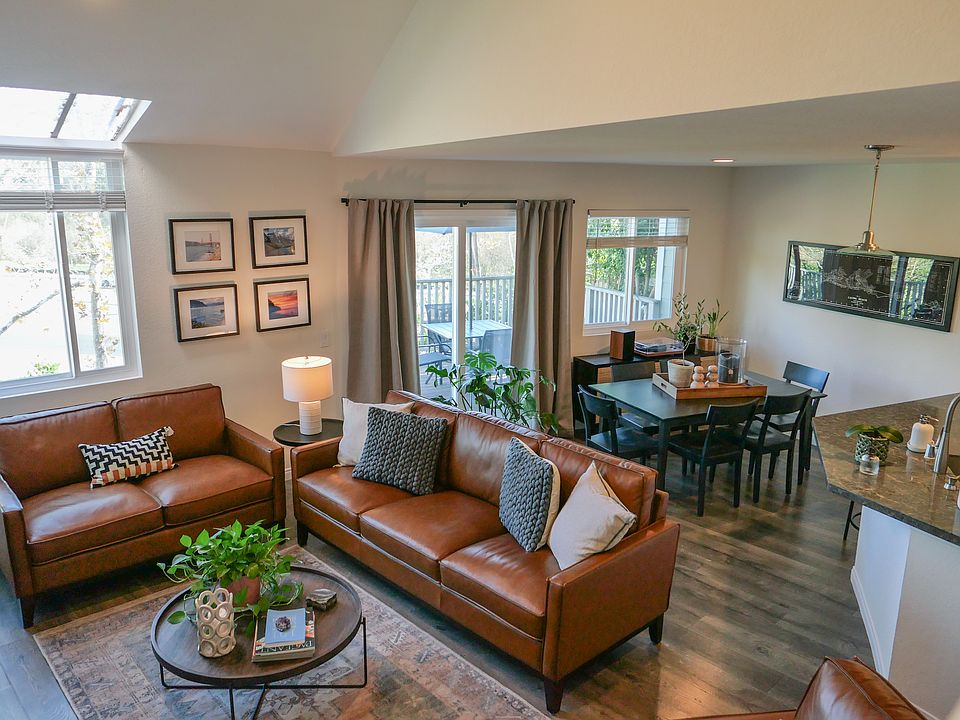 Light and bright living room, newer dual pane windows and slider lead out to large deck