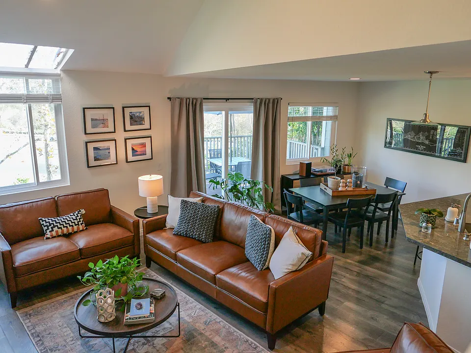 Light and bright living room, newer dual pane windows and slider lead out to large deck