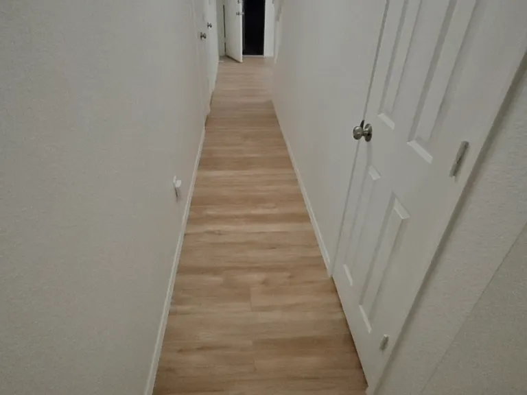 Down stairs hallway runs from the front of the house and leads to the back yard. Provides access from the garage and connects the two downstairs bedrooms and bathroom, linen closet and utility closet.