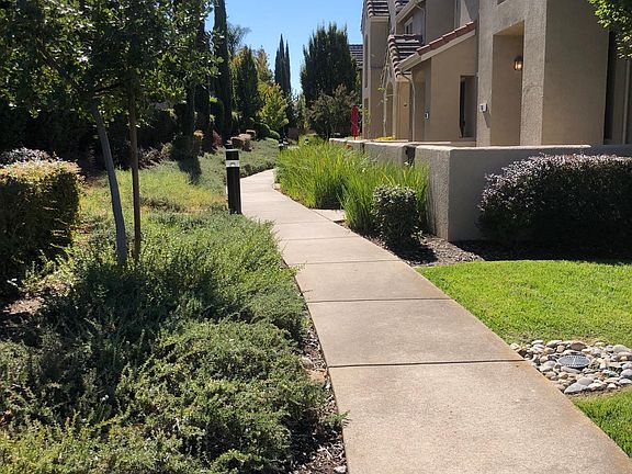 Grass area outside condo and walkway