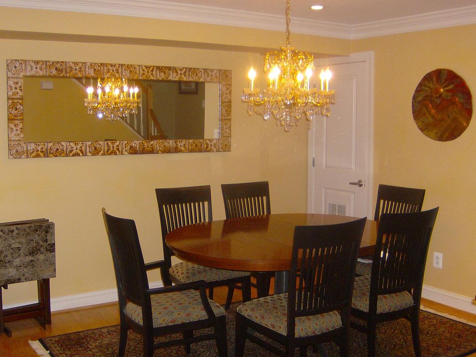 Dining room with chandelier and antique mirror