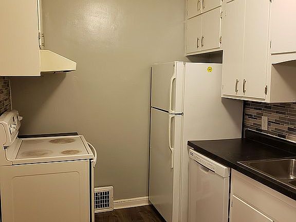 Kitchen includes refrigerator, microwave, dishwasher, garbage disposal, stove.