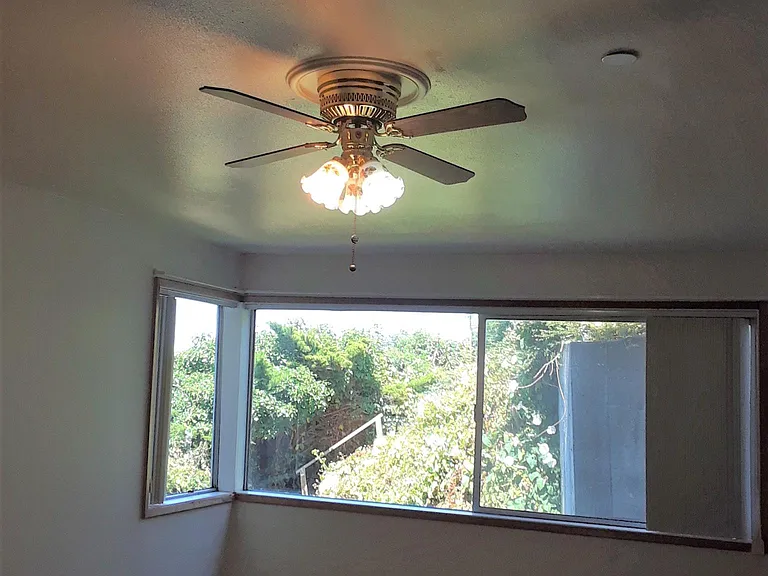 Master Bedroom with ceiling fan and windows
