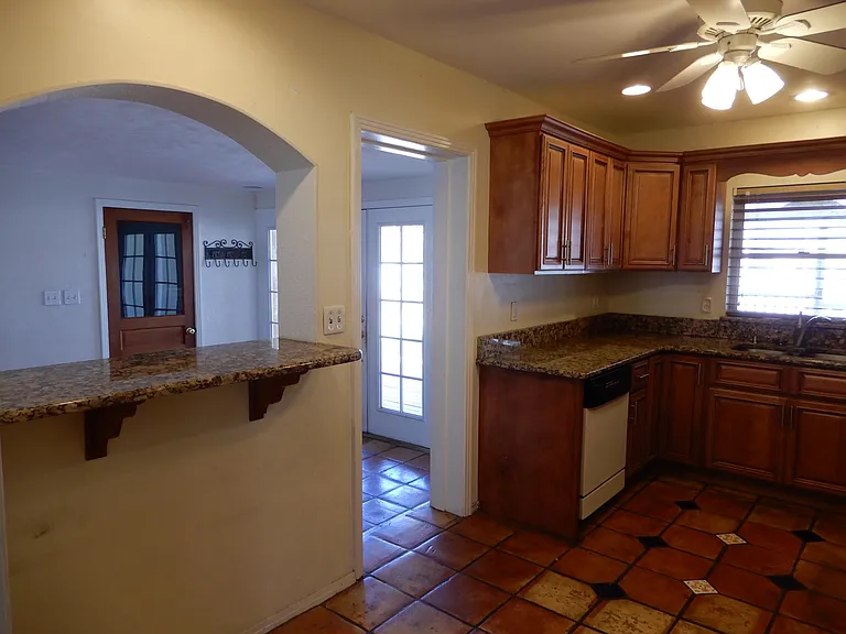 Granite counter tops, real wood cabinets, recessed ceiling lights and ceiling fan with lights.