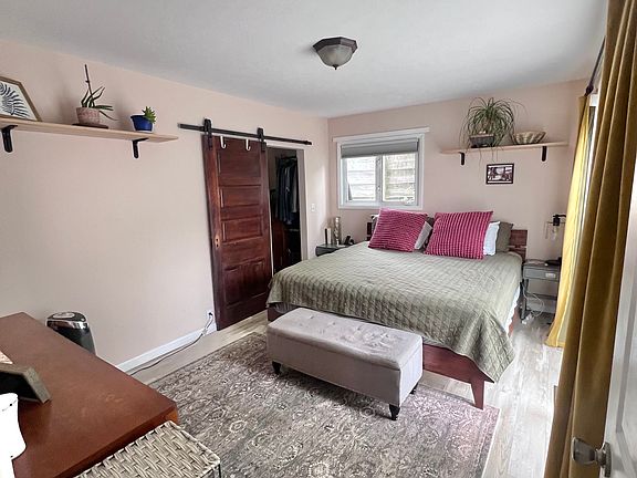 Master bedroom. Doors on the right open to the patio and fenced in backyard.