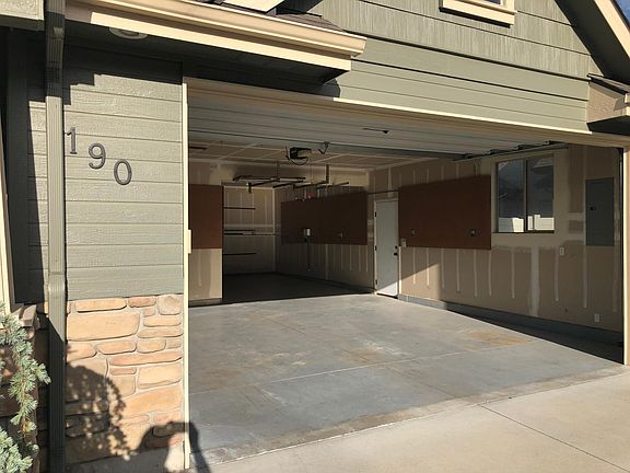 Three car garage with lots of storage (two attic stairs, peg board, ceiling brackets).
