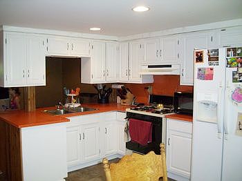 Light bright kitchen with appliances.
