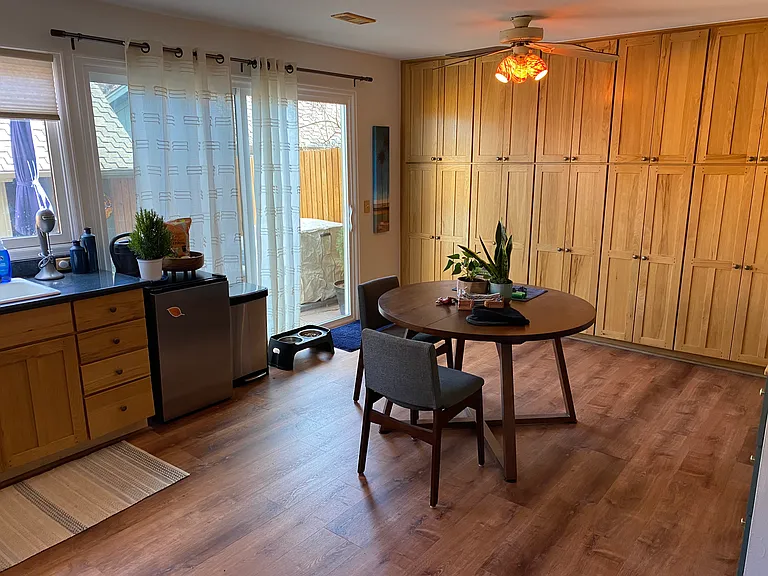 kitchen table and lots of storage in the custom shelving behind it.