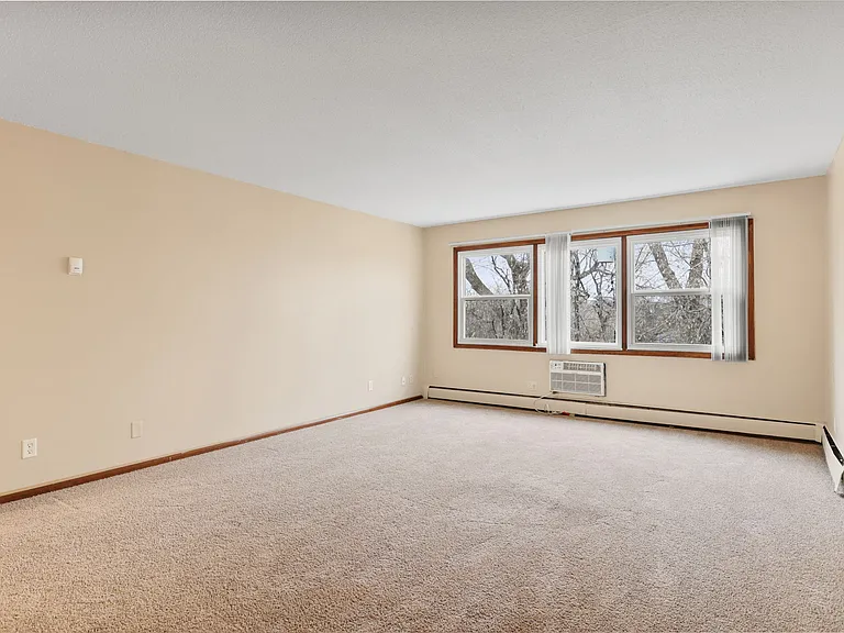 Living room with wall unit air conditioning