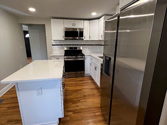 Beautiful kitchen with gas stove, mounted microwave, and dishwasher.