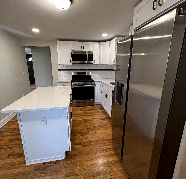 Beautiful kitchen with gas stove, mounted microwave, and dishwasher.