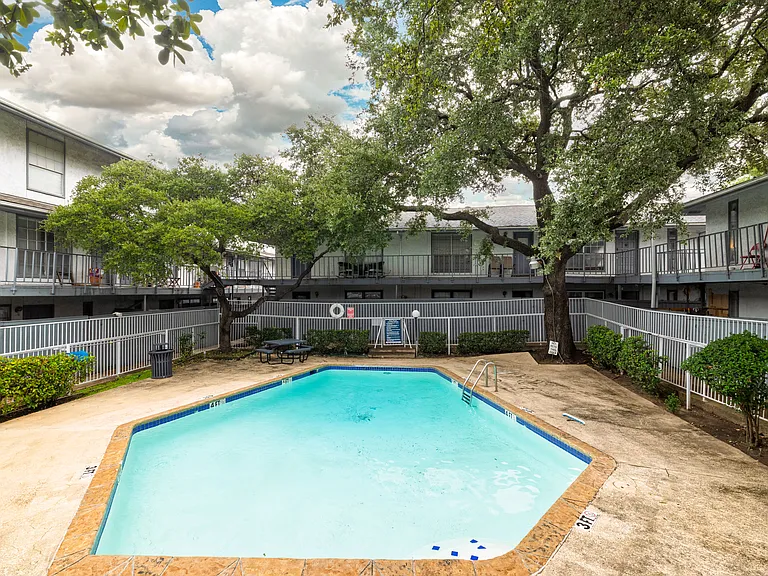 Take advantage of the community pool, surrounded by shade trees and lounge seating. A refreshing spot to relax during your stay.