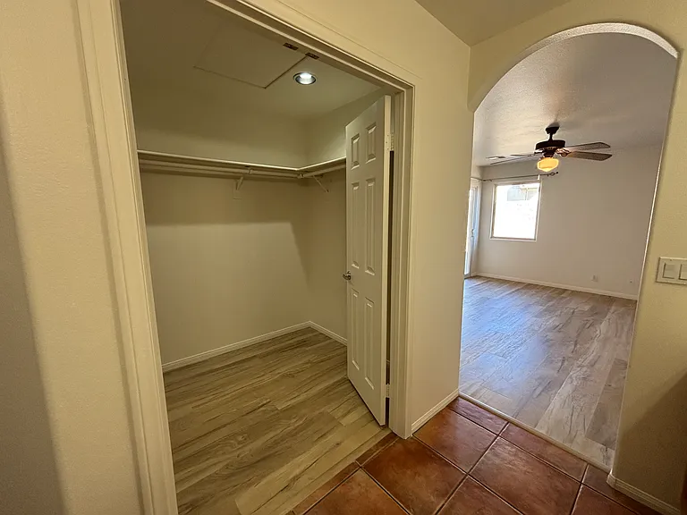 Walk-in closet with built-in shelving and convenient access from the primary bedroom.